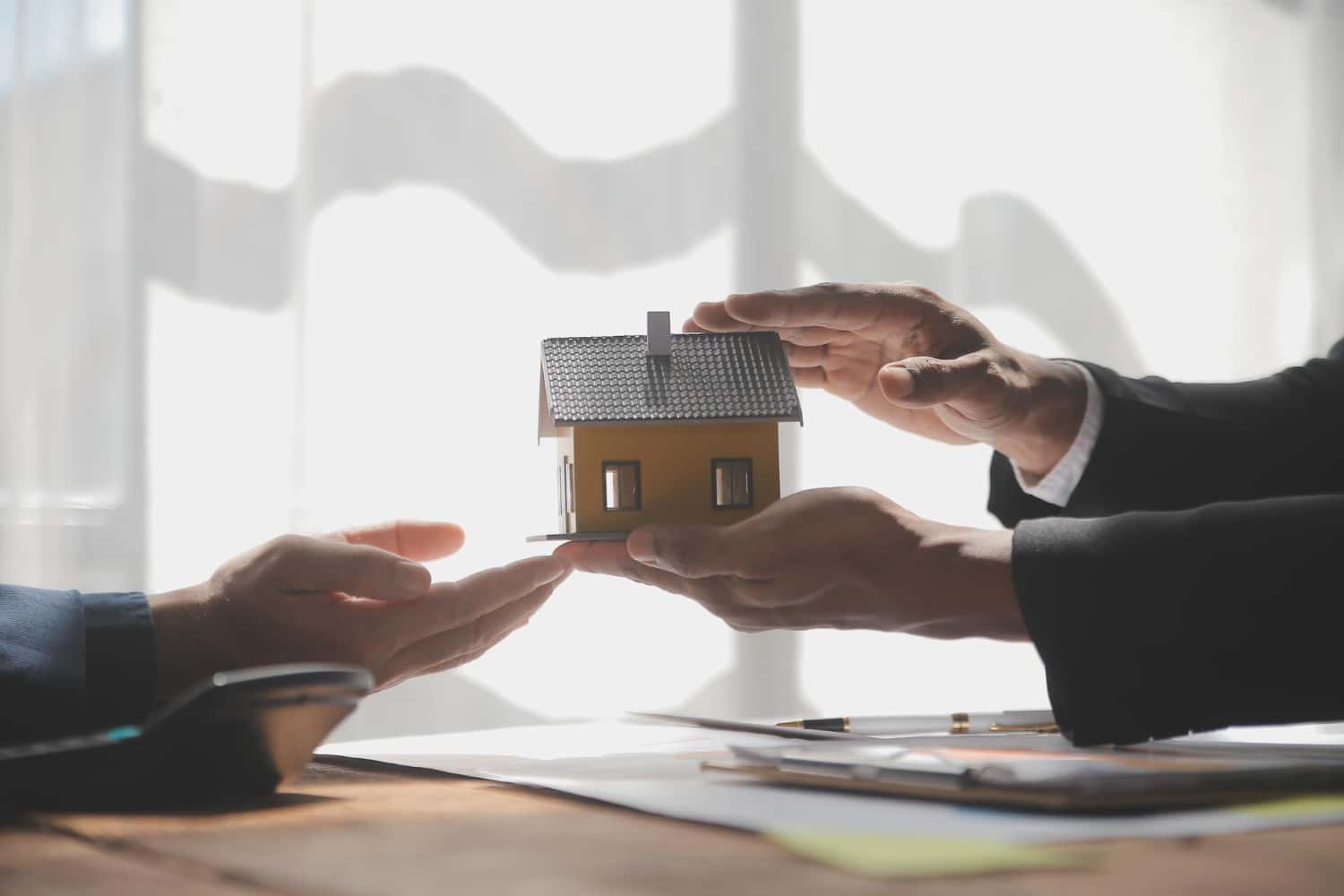 Real estate agent and customer signing contract of mortgage