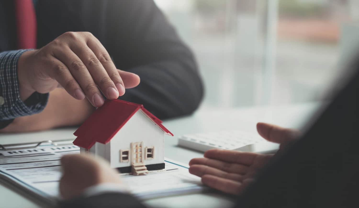 agent is explaining the house style to the clients who come to contact to see the house design