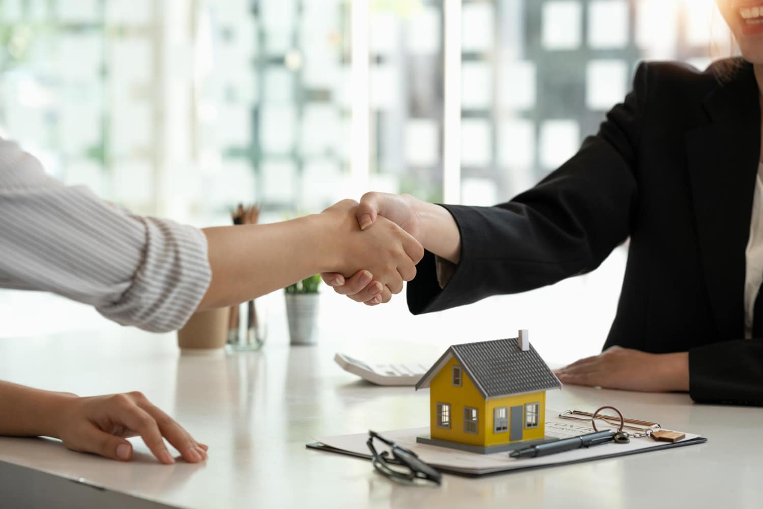 broker and customer shaking hands after deal